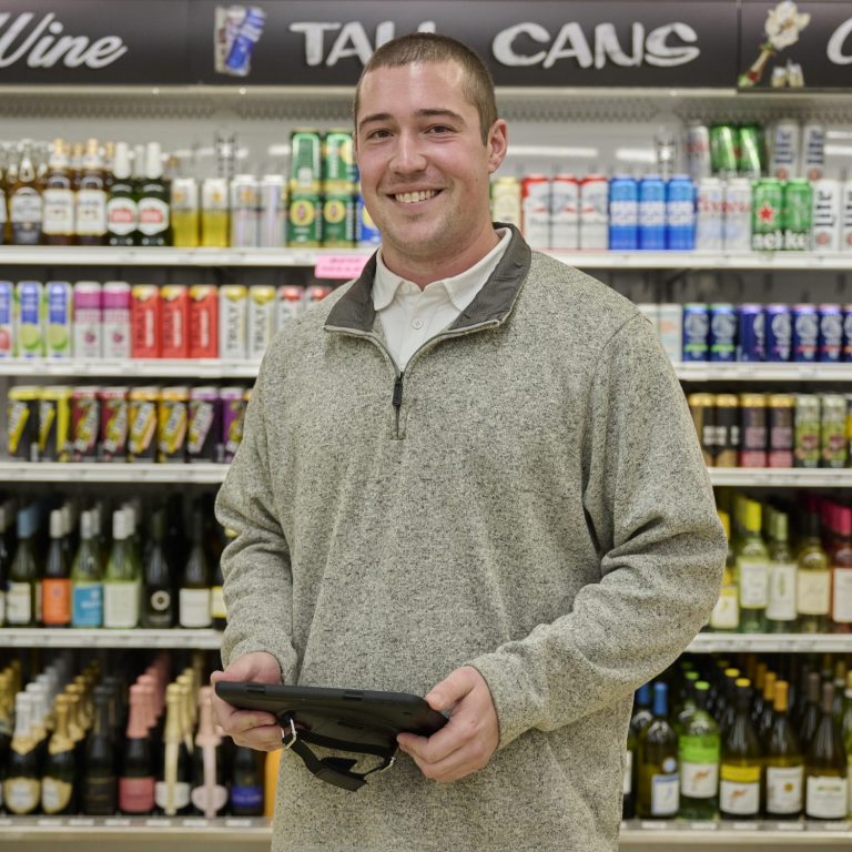 sales rep posing at an off premise package store